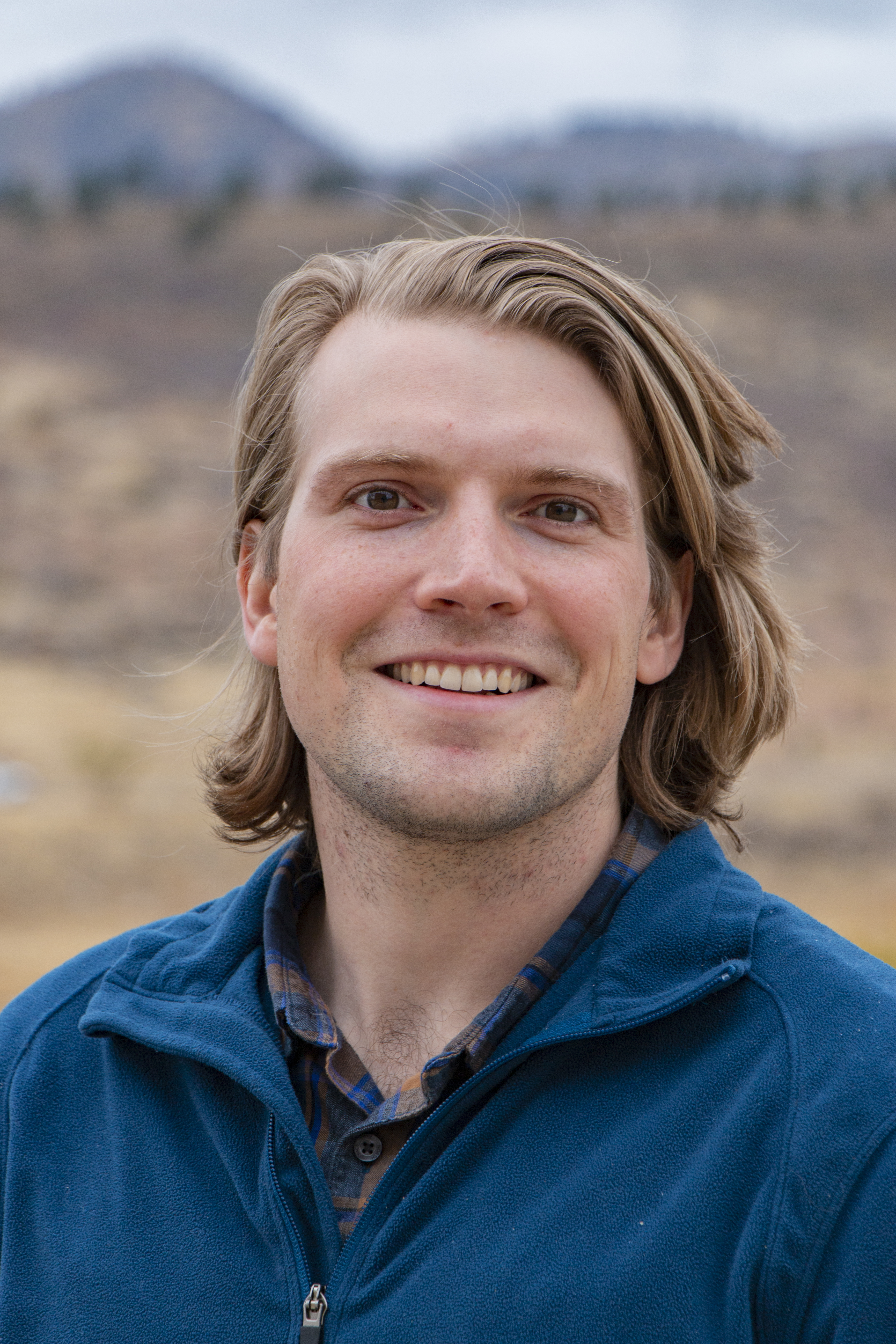 Head shot of Alex DesRosiers with foothills backdrop